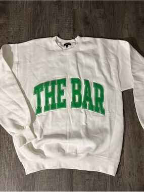 The Bar White Crew Sweatshirt with Green Arch Logo